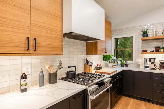 Kitchen with wood-grain upper cabinets, dark lower cabinets, white subway tile and open wood shelving by MJ Kitchen & Bath